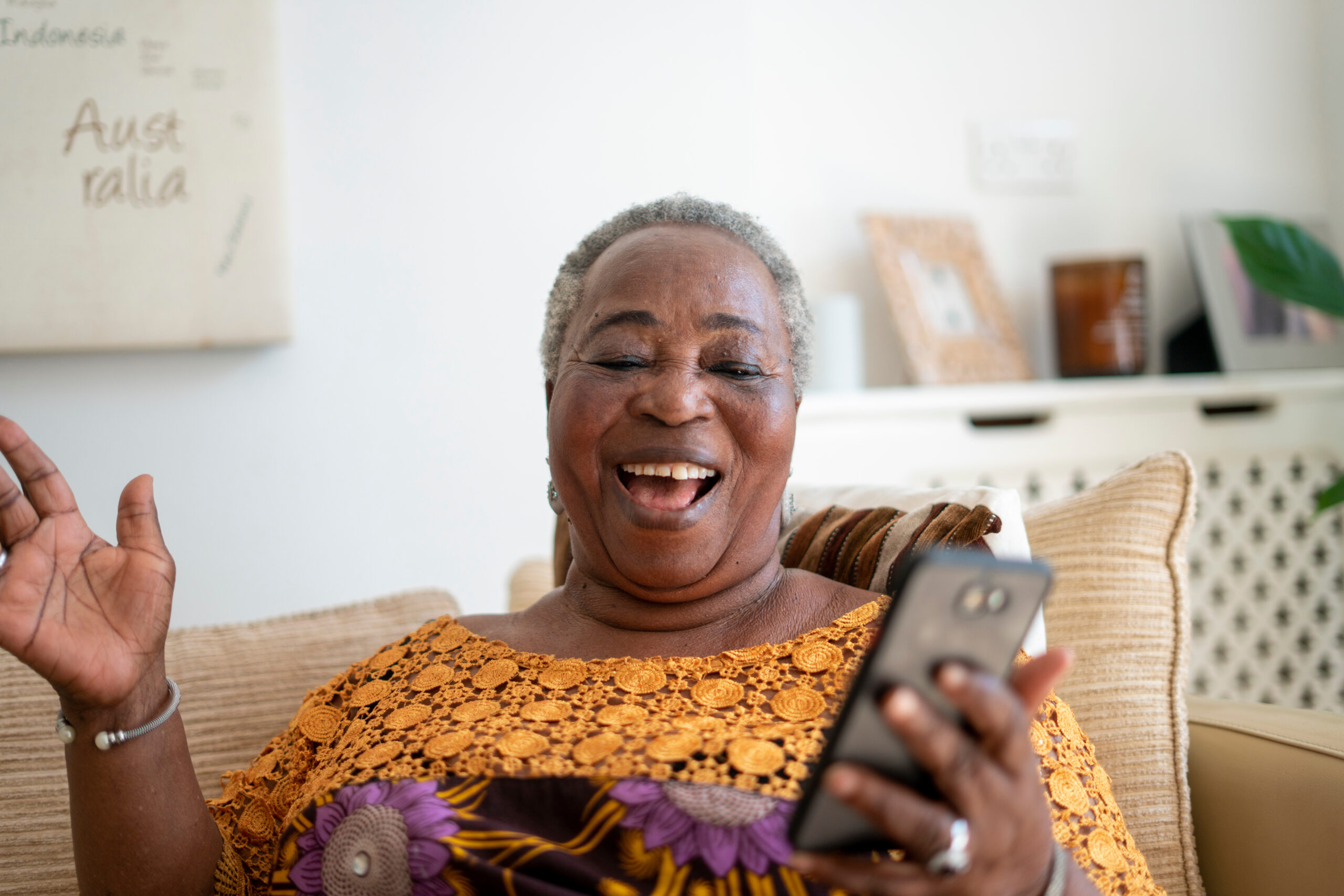 Smiling older woman having video call on smart phone at home Smiling older woman having video call on smart phone at home